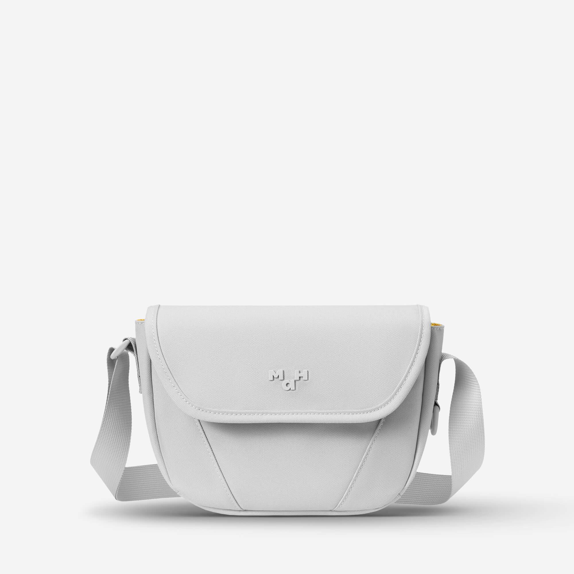 Light gray crossbody bag with adjustable strap and minimalist design, ideal for everyday use