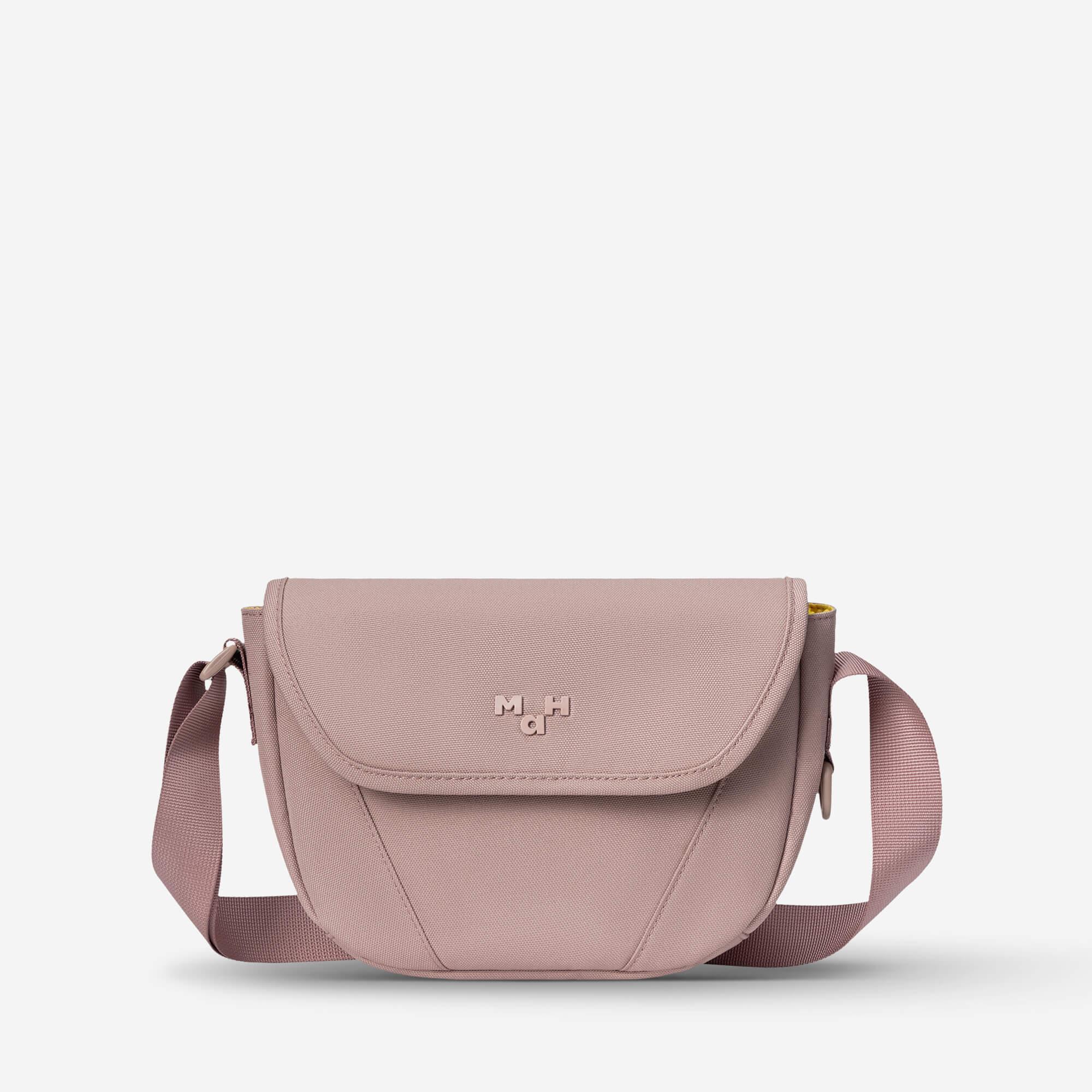 Dusty pink crossbody bag with adjustable strap and front flap, ideal for everyday use