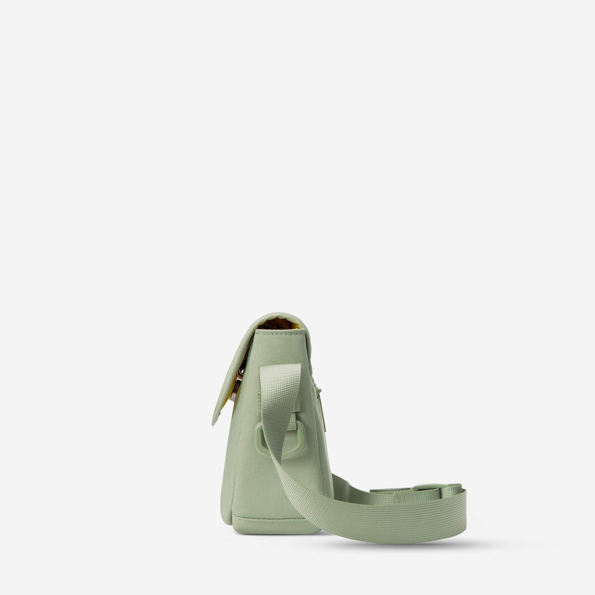 Mint green crossbody bag with adjustable strap and flap closure, ideal for everyday use