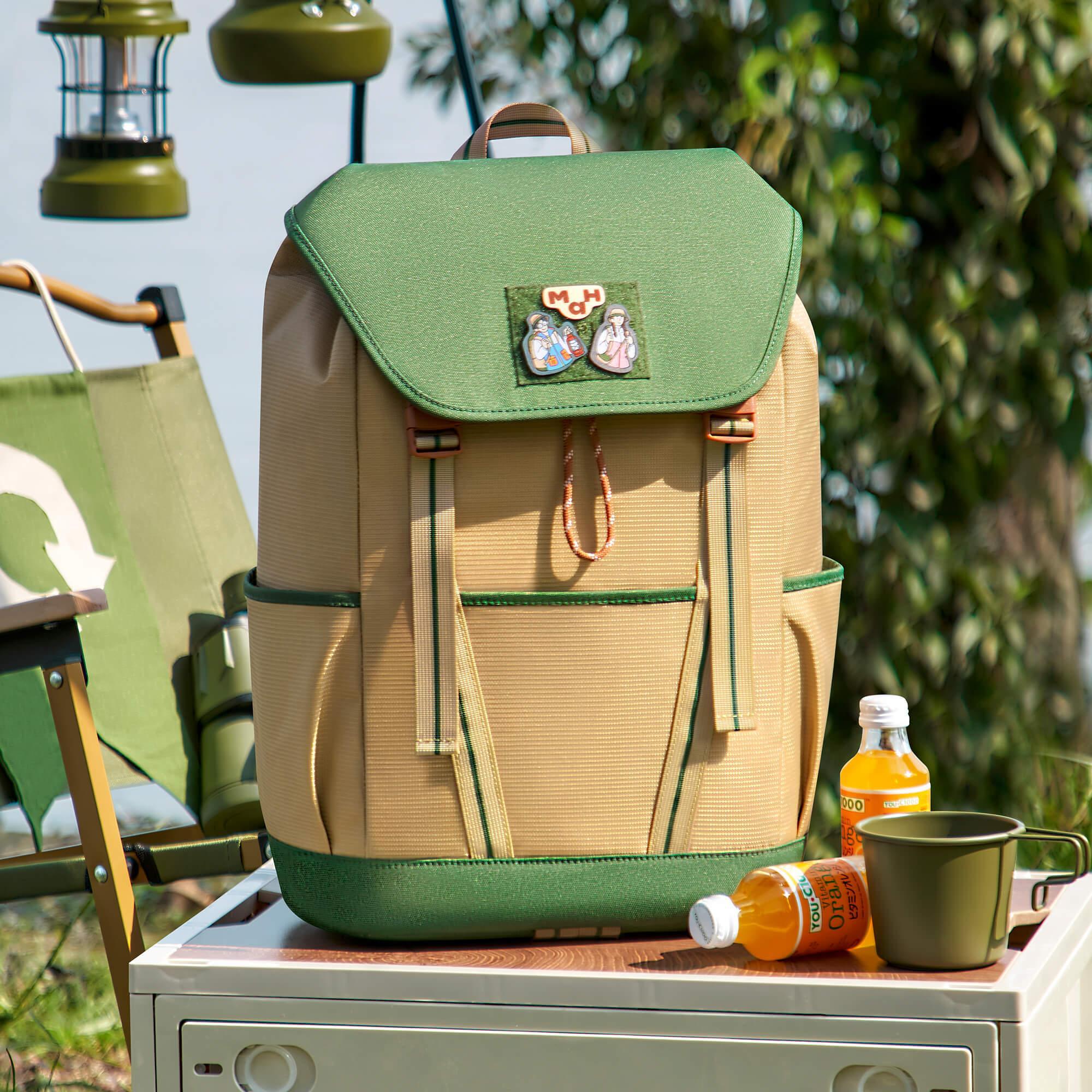 Green and beige outdoor backpack with camp accessories, perfect for hiking and travel adventures.