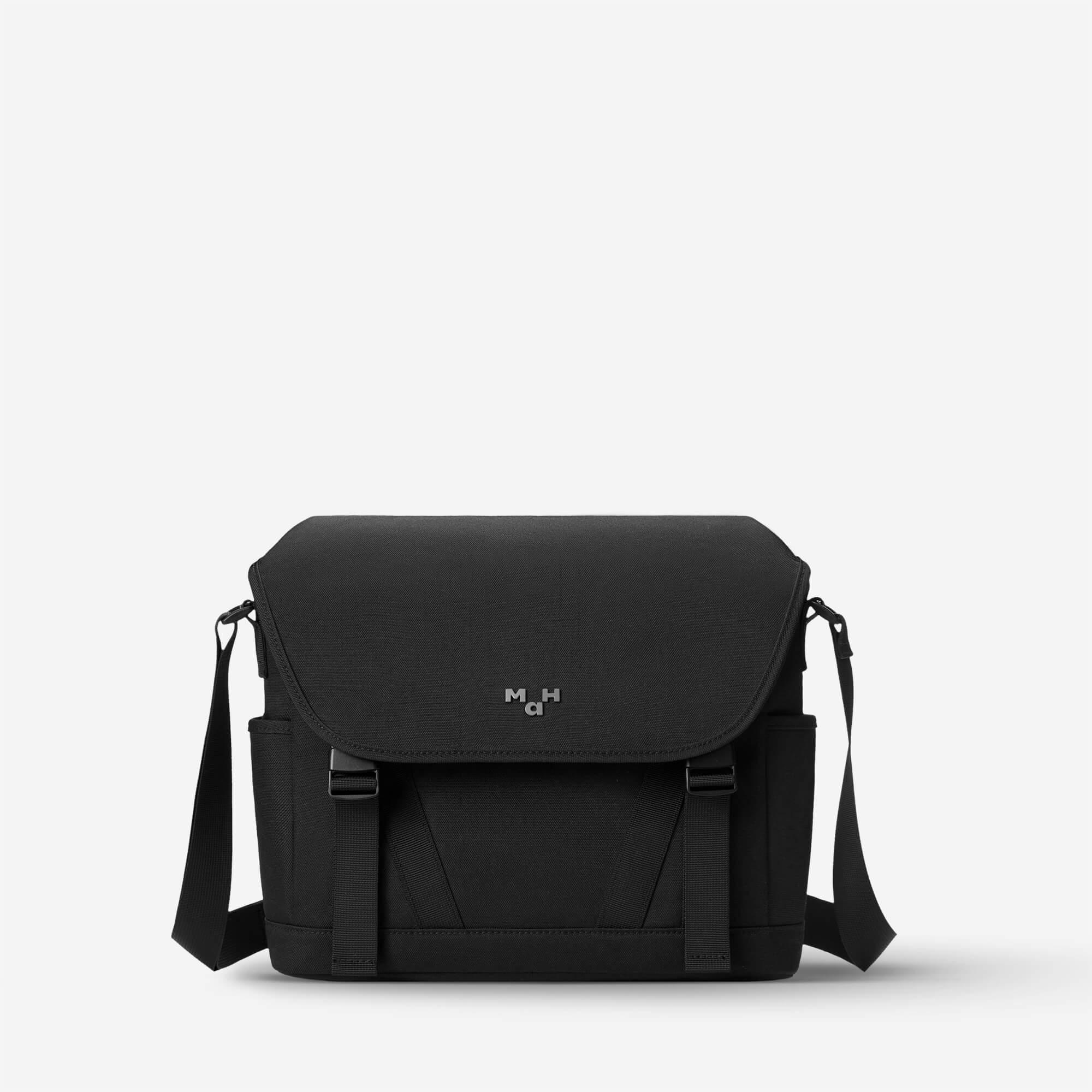 Black messenger bag with adjustable strap and front flap, ideal for everyday carry and urban style.