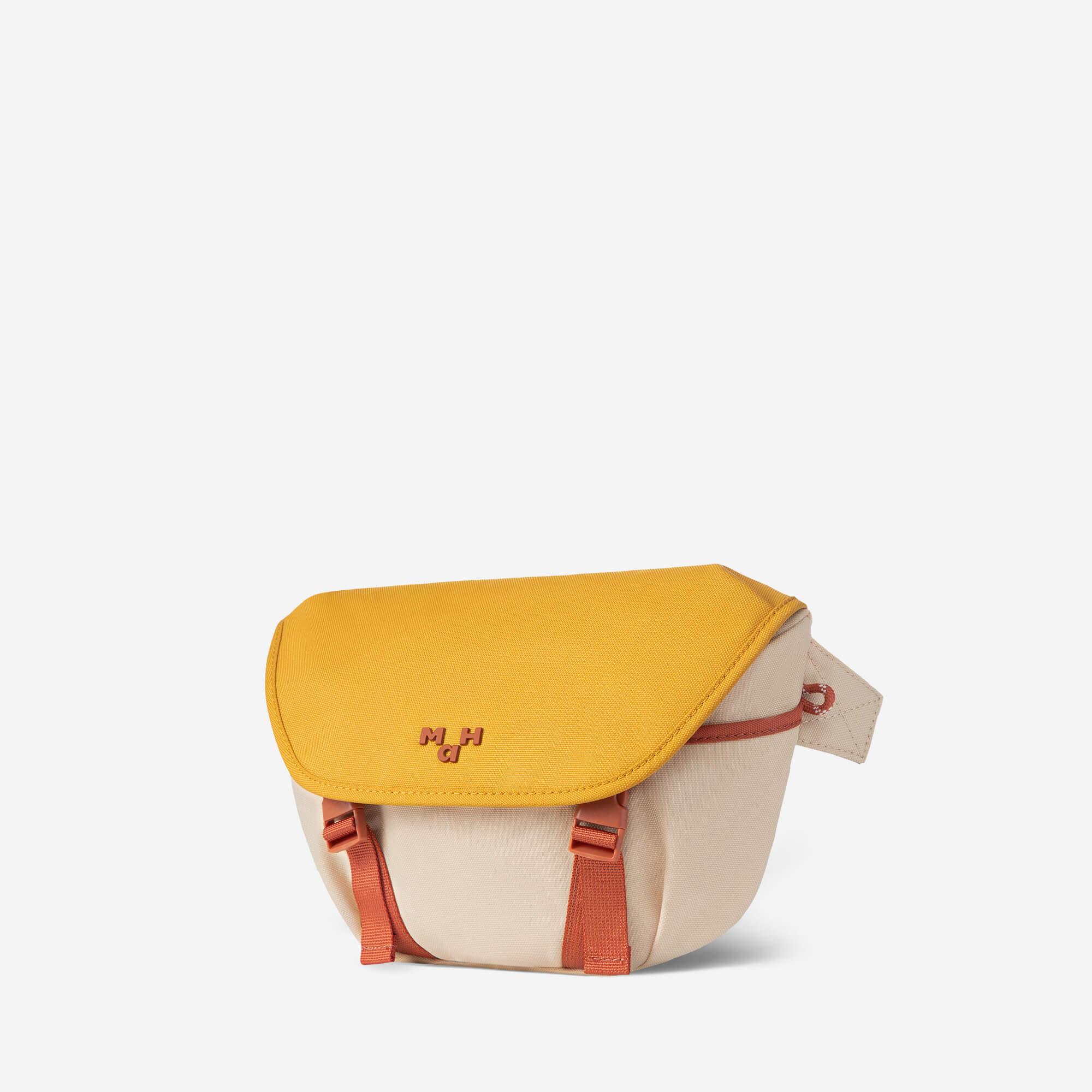 Mustard yellow and beige crossbody bag with orange straps and logo, stylish everyday accessory