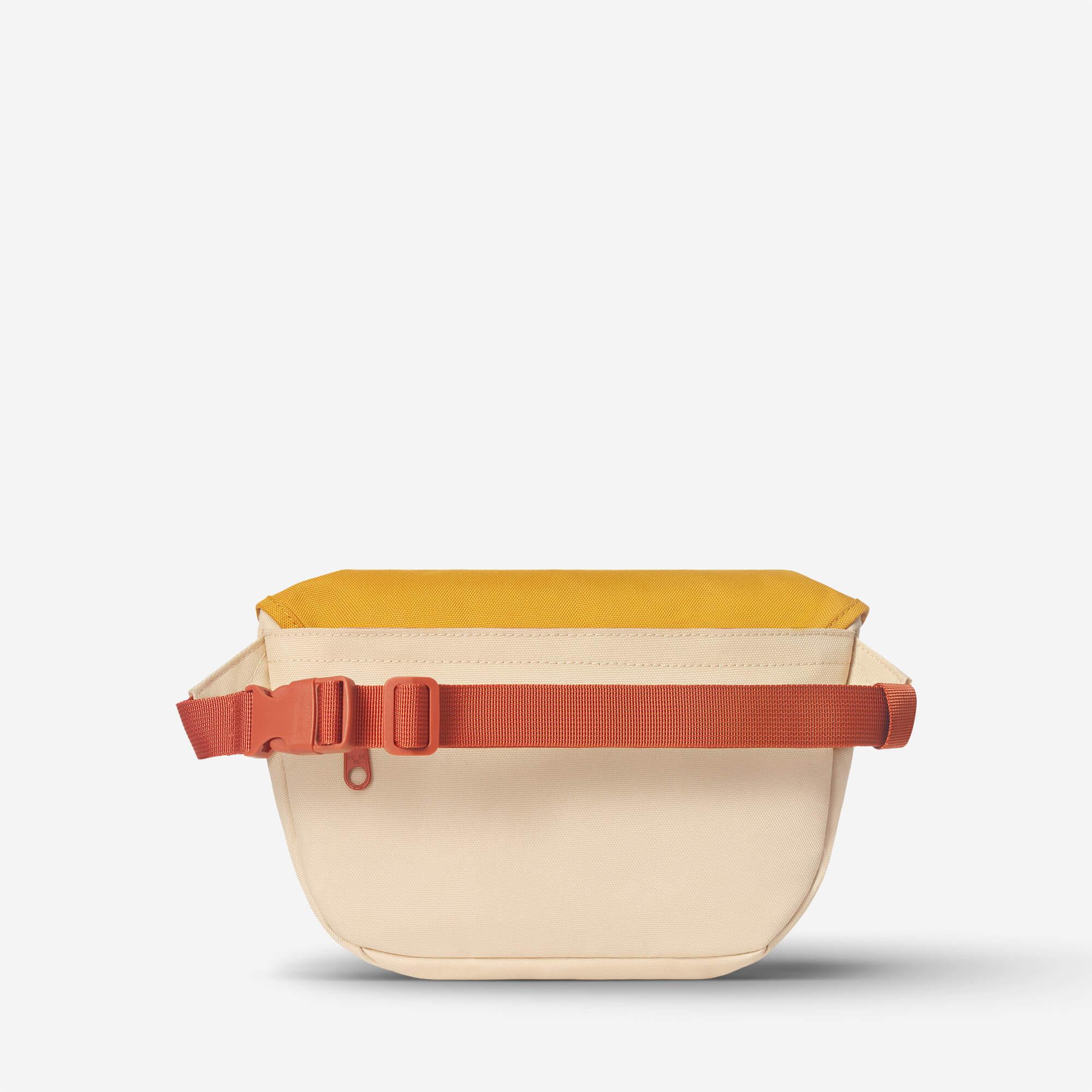 Beige and mustard fanny pack with orange adjustable strap, ideal for travel and daily use