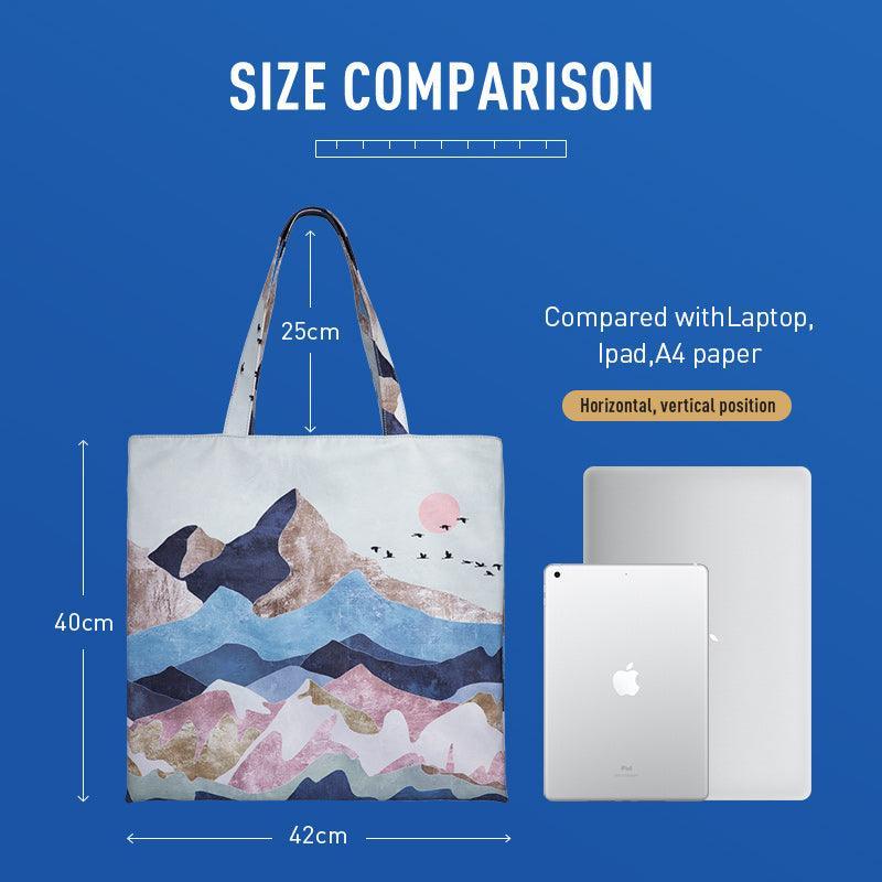 Minimalist white backpack with abstract print, 42cm wide, shown beside laptop for scale